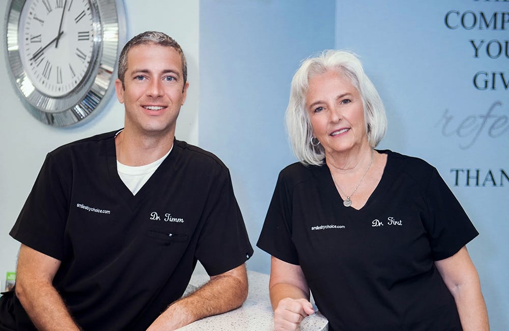 Dr. Timm and Dr. First standing side by side at the office reception area